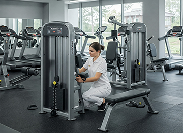 A technician completes a CMMS work order on a fitness machine.
