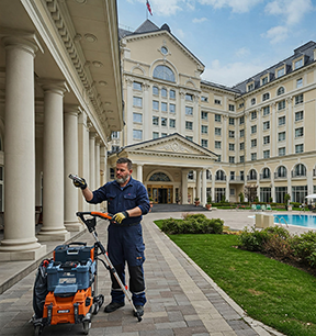 A maintenance worker completes a CMMS work order for hotel maintenance.