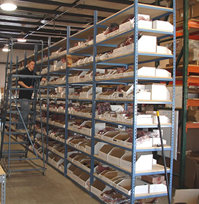 Shelves of inventory organized through a CMMS.