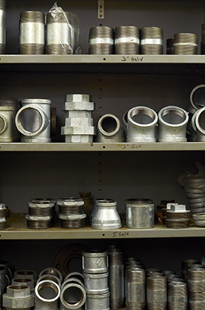 A collection of fittings organized in the stockroom by a CMMS