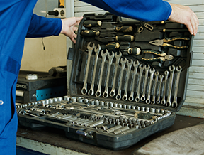 A maintenance worker gathers his tools for effective wrench time.